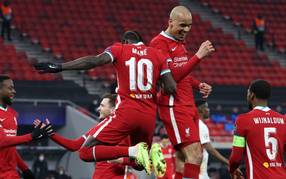 Liverpool's second scorer Sadio Mane gets in tune with Fabinho to celebrate clinching a 2-0 win over RB Leipzig in Budapest