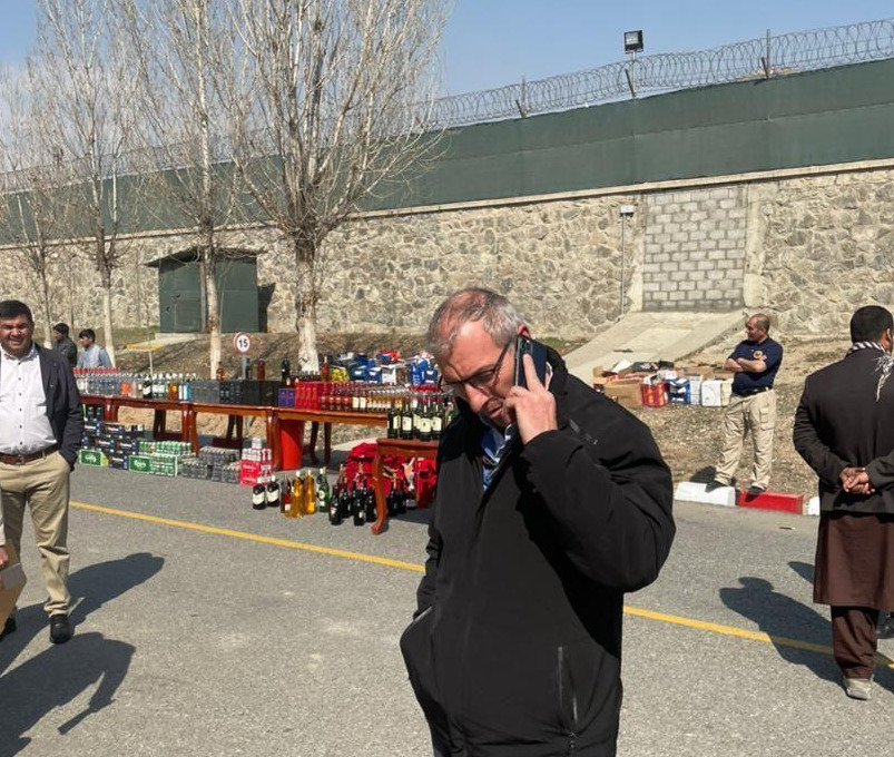 The former Red Cap, above, was allowed to make a phone call when police paraded him in front of the bumper haul