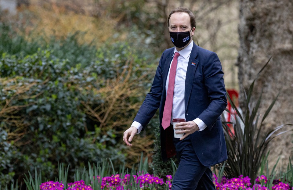 The Health Secretary makes sure his face mask is on before walking into No10