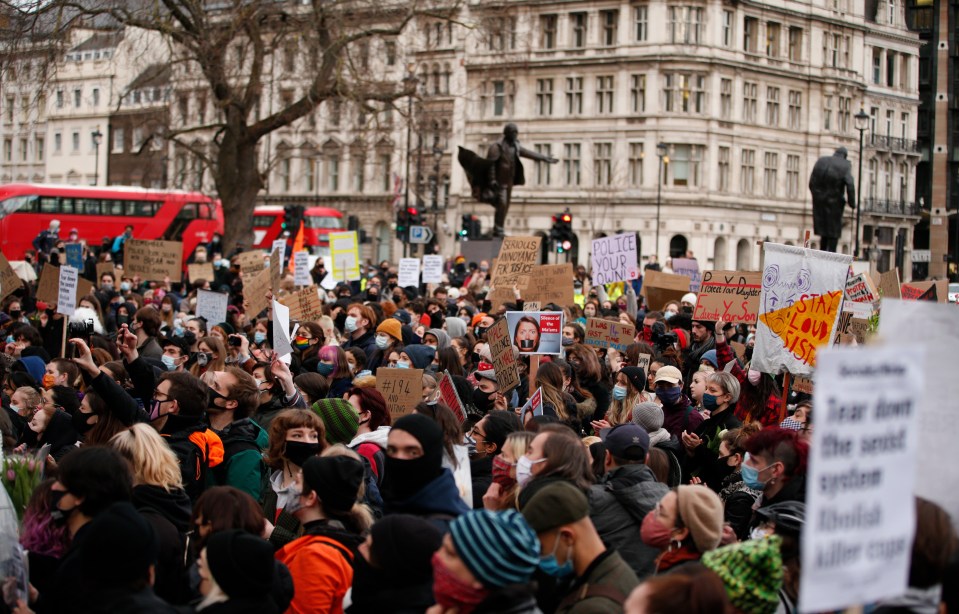 People are seen outside Westminster protesting the death of Sarah Everard