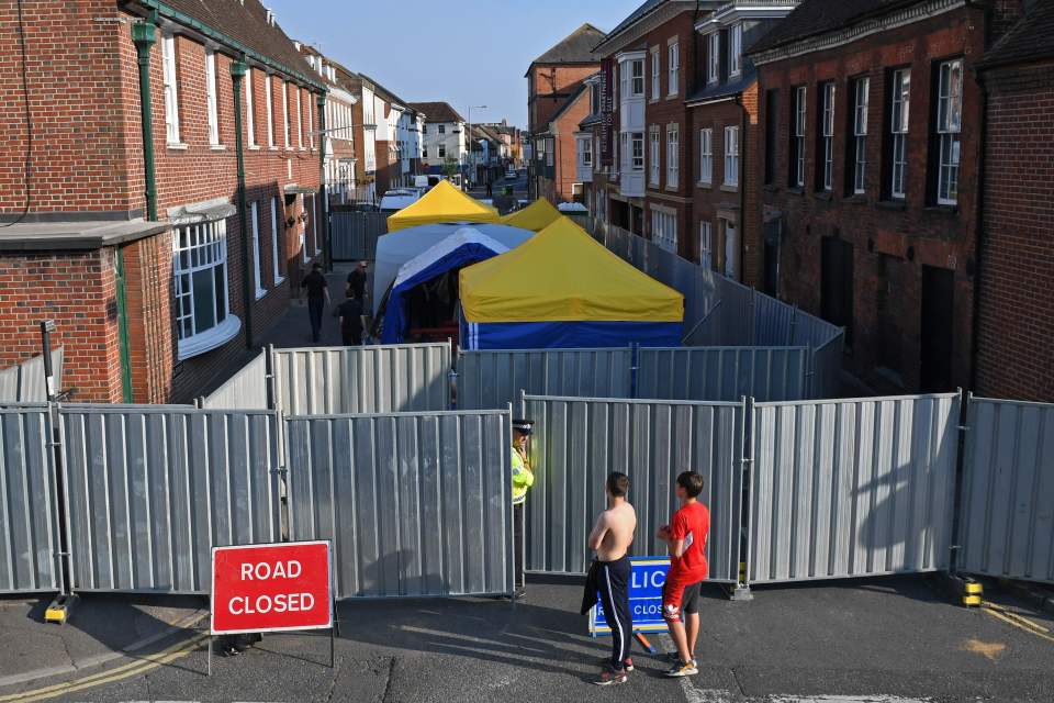 Work goes on behind the barriers across Rollestone Street, outside the John Baker House Sanctuary Supported Living in Amesbury on July 5, 2018