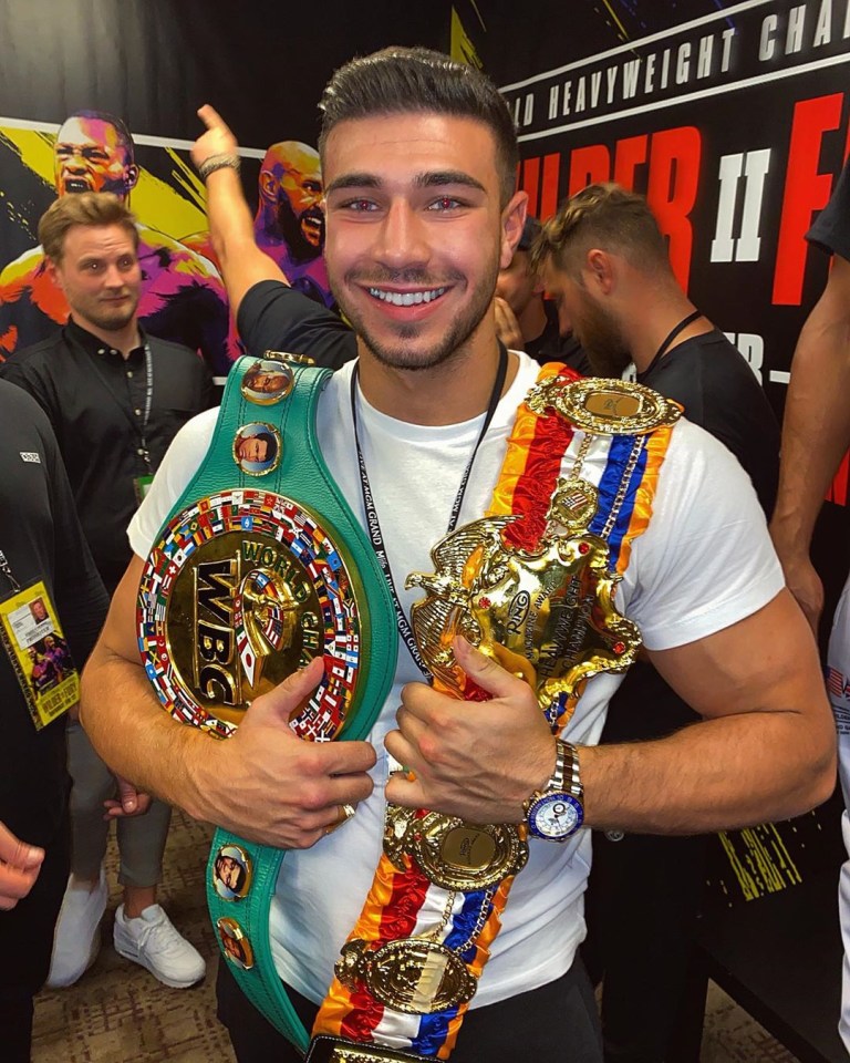 Tommy Fury pictured with brother Tyson's WBC and Ring Magazine belts