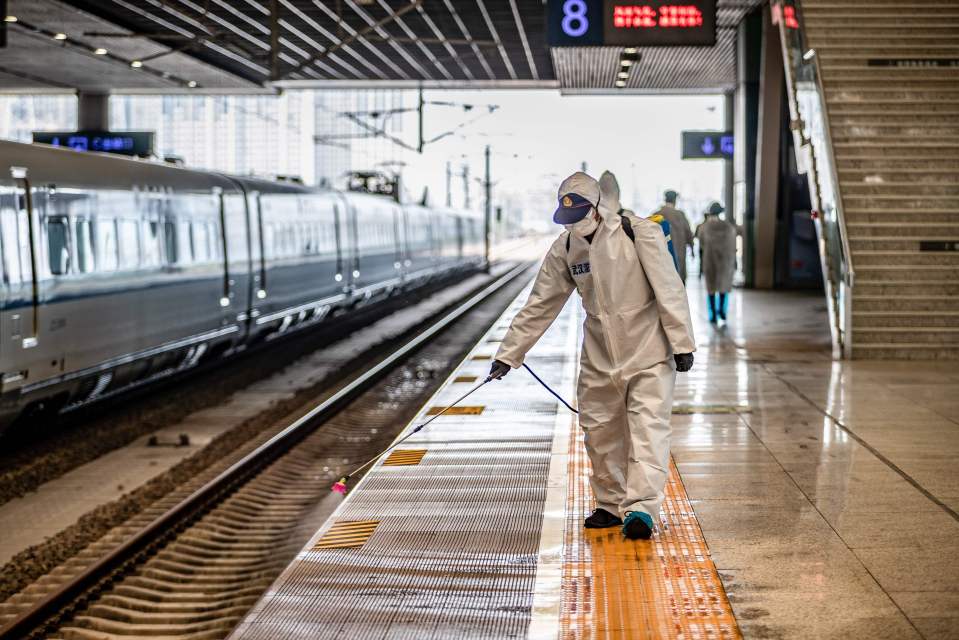 Staff sprays disinfectant at Wuhan Railway Station during lockdown in March 2020