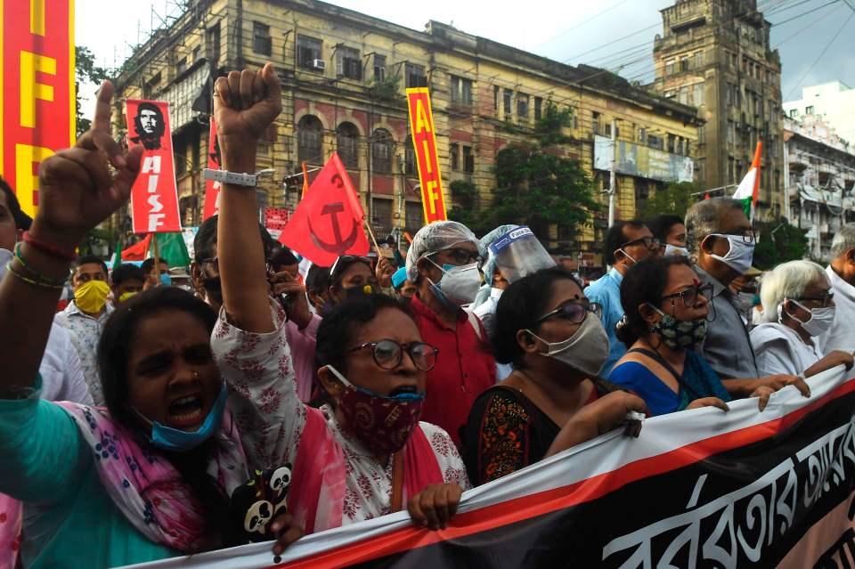 Protesters walk in a rally protesting in opposition to atrocities against women in Utaar Pradesh