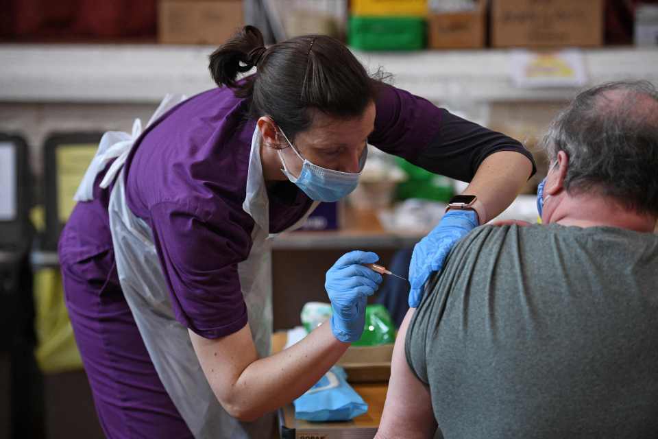 A man receives his vaccination in the UK - with hopes all adults will receive a jab by June