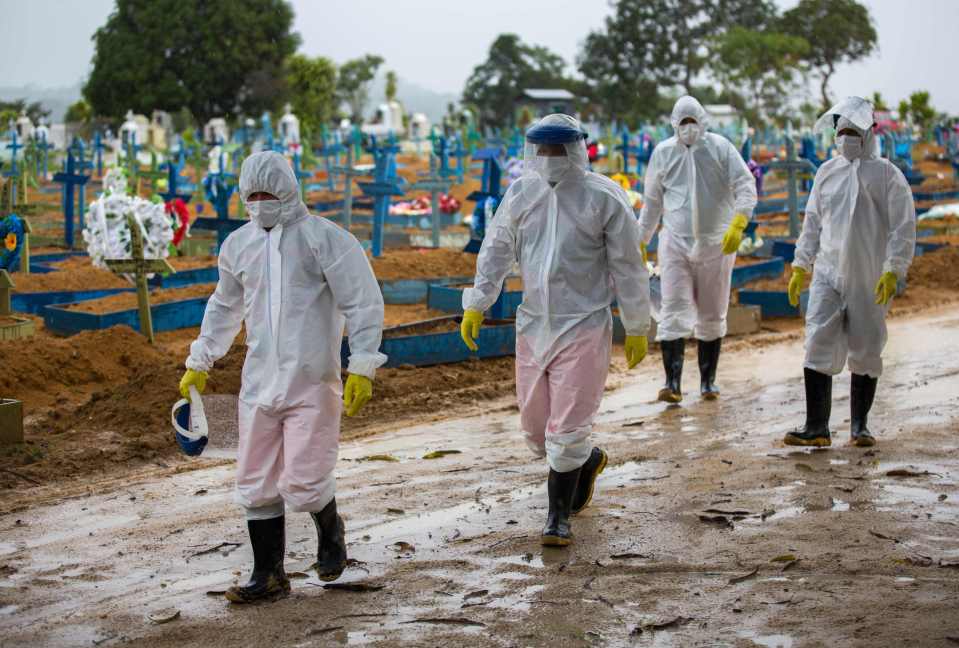 Experts first detected the P.1 variant in Manaus, north Brazil, in December. Pictured: Workers in PPE walk past the graves of Covid-19 victims in the city, February 25