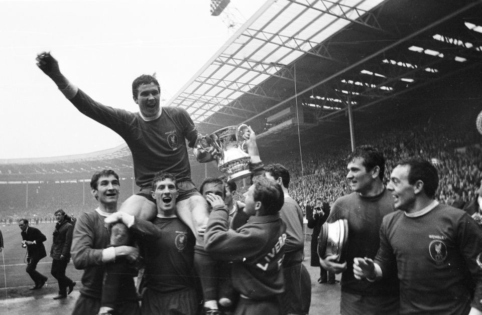 Captain of Liverpool FC, Ron Yeats holds the FA cup with Ian St John on the far right