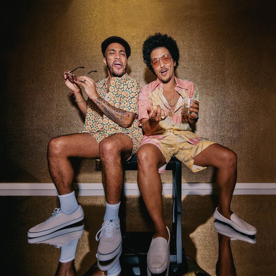 Bruno Mars (right) models his first clothing collection for Lacoste with his musician pal Anderson Paak (left)