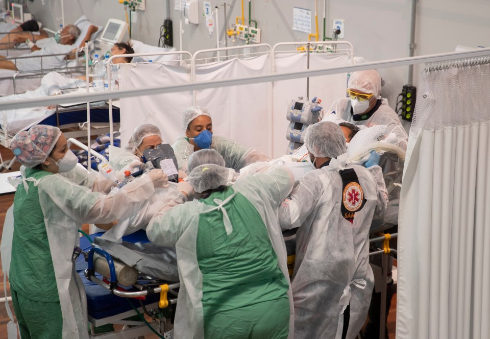 Medics care for a seriously ill Covid patient in a field hospital at a sports arena in Sao Paulo