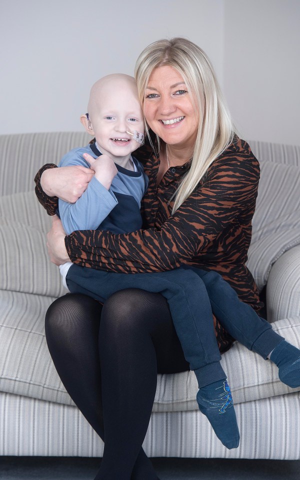 Ollie, 4, enjoys a cuddle with mum Lucy