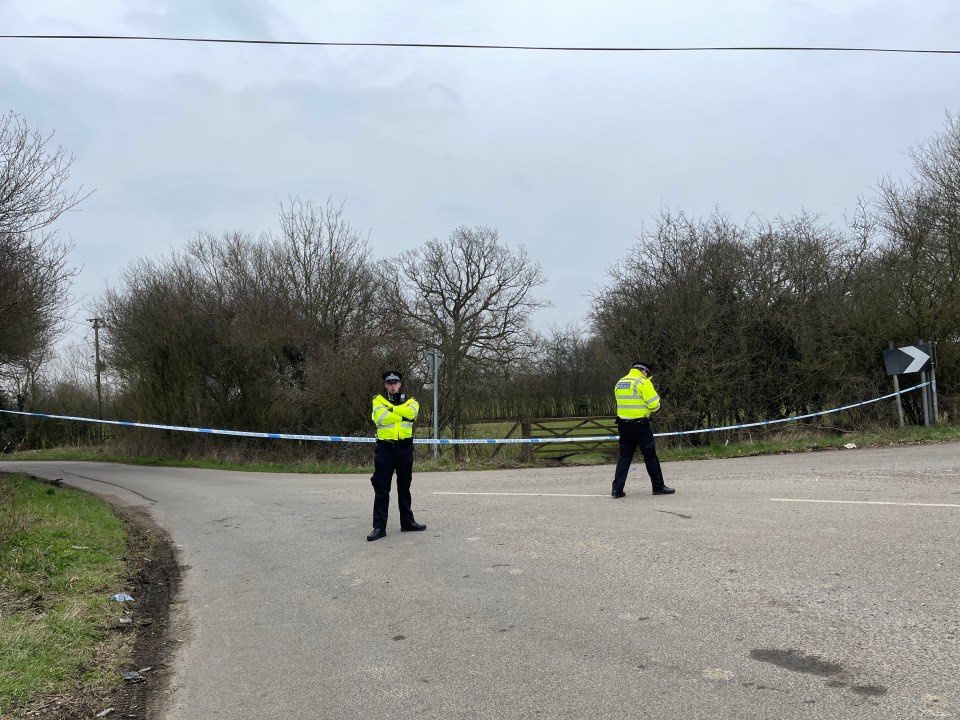 Officers stand guard as the investigation into Sarah's disappearance continues