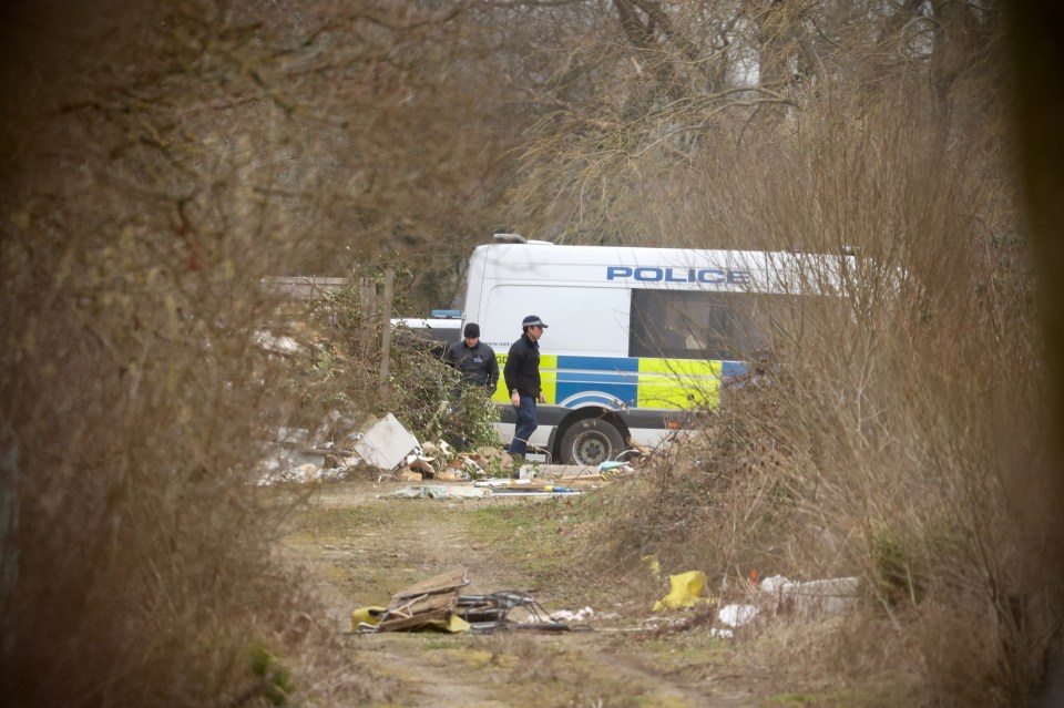 A police van at a woodland site on Wednesday