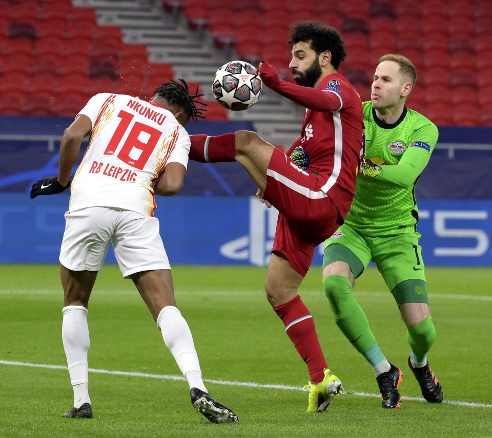 Mo Salah tussles with RB Leipzig's Christopher Nkunku and keeper Peter Gulacsi