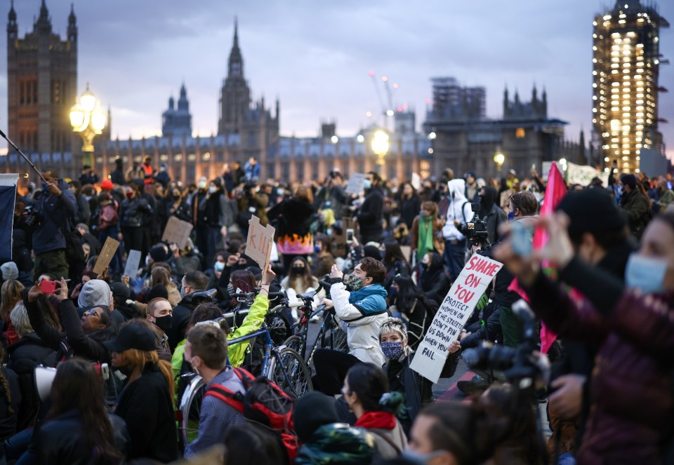 Demonstrators sit in the street on Westminster Bridge