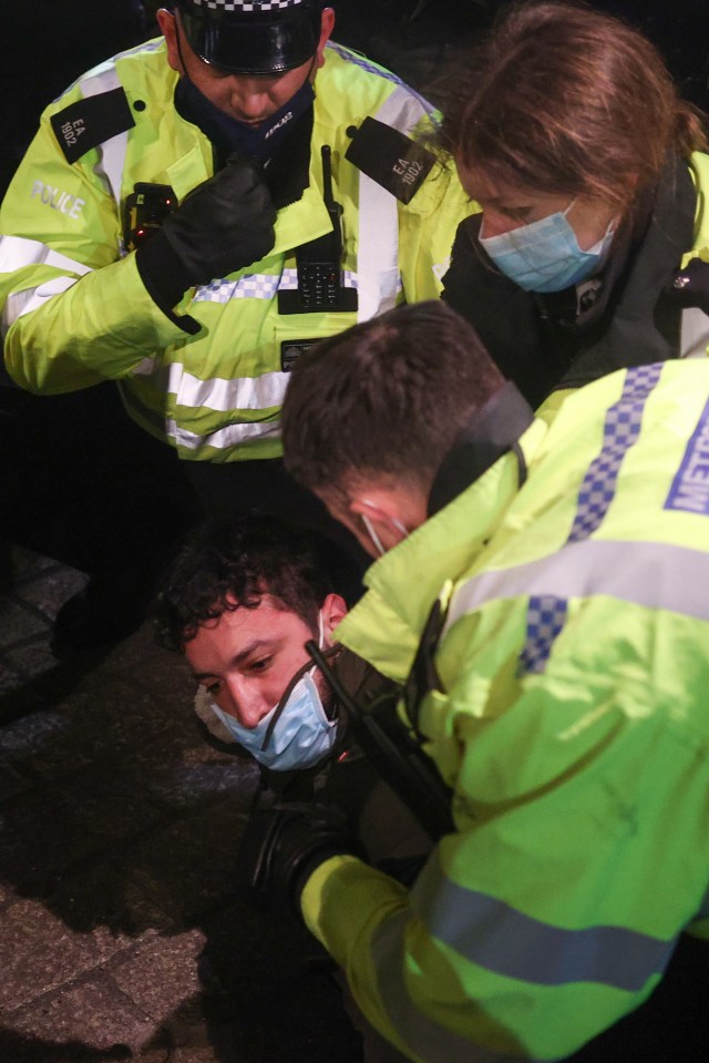 Officers arresting one of the protesters