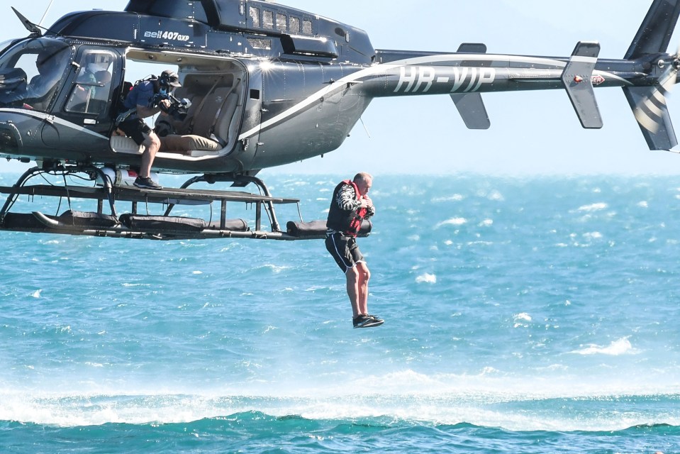 The former footie star dropped out of a helicopter and swam to a desert island as the show kicked off