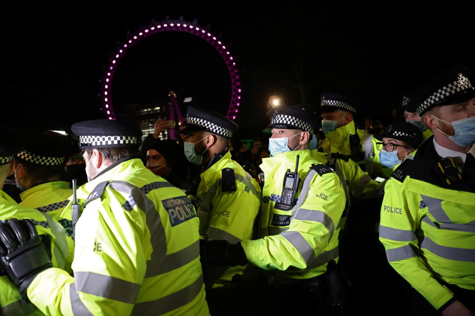 Police officers form ranks during a scuffle