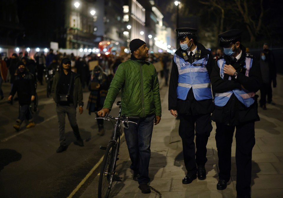 A man argues with the police while marching