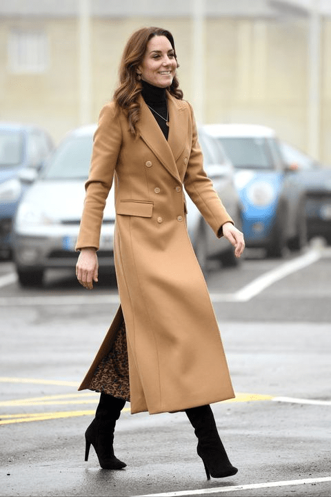 Kate Middleton smiles as she visits the ambulance station