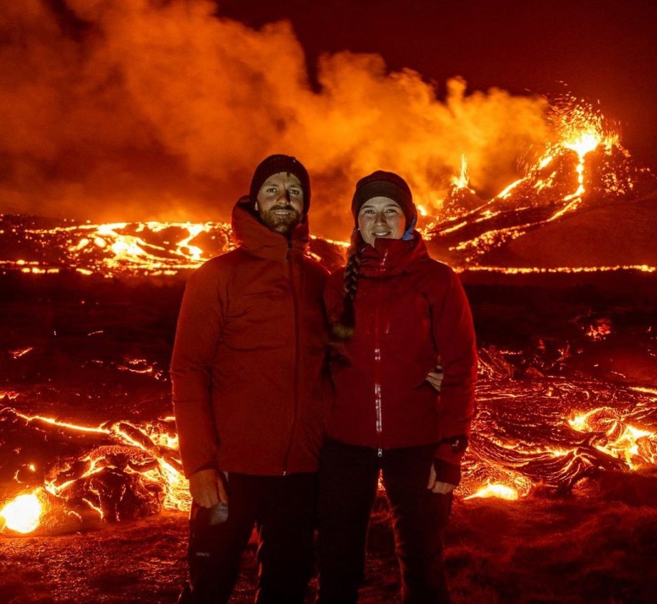 Daredevils pose near erupting volcano