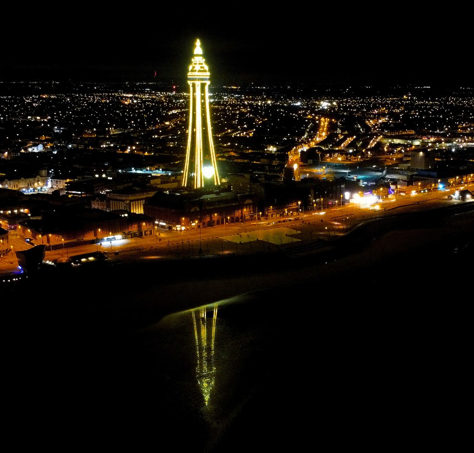 Blackpool Tower is seen lit up yellow last night to mark the anniversary of the first national lockdown