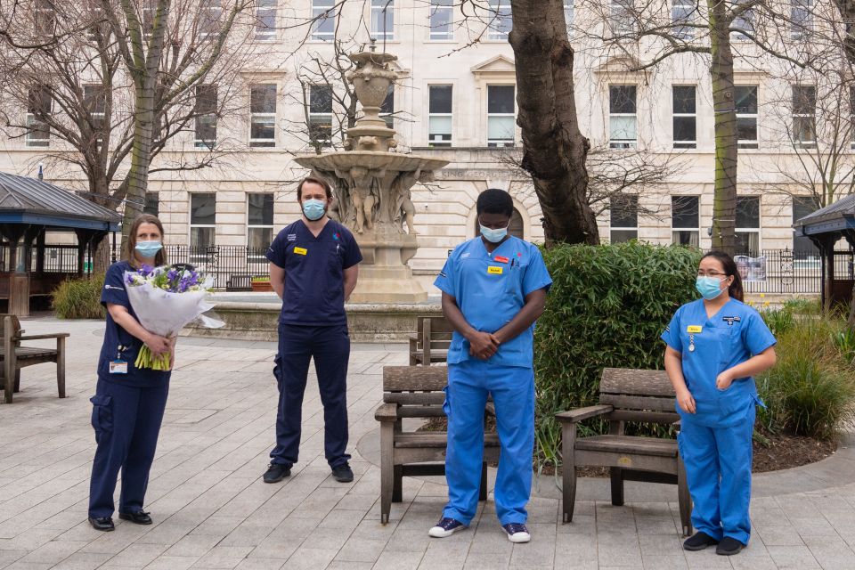 Medics at St Bartholomew's Hospital, London mark a minute's silence and hold a bouquet of flowers gifted to them by The Queen. Prince Philip was recently treated at the hospital.