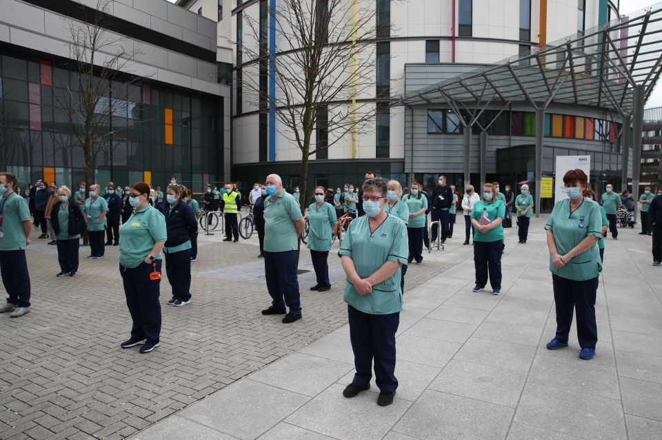 Staff observe a minute's silence outside the Queen Elizabeth University Hospital in Glasgow