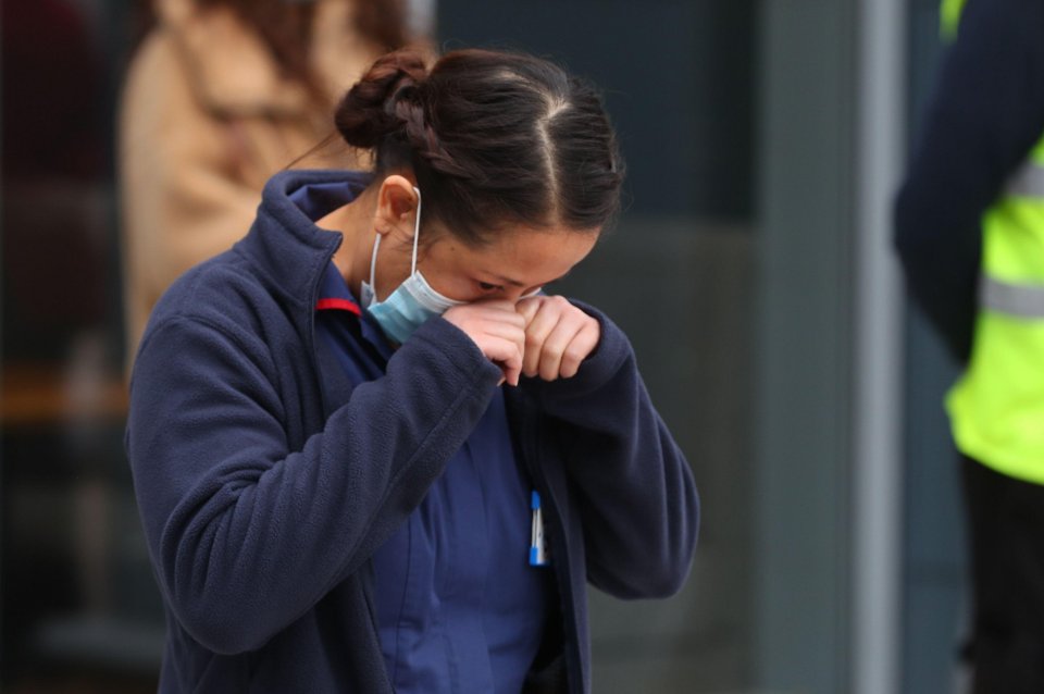 A health worker at University Hospital Southampton wipes away tears during the minute's silence