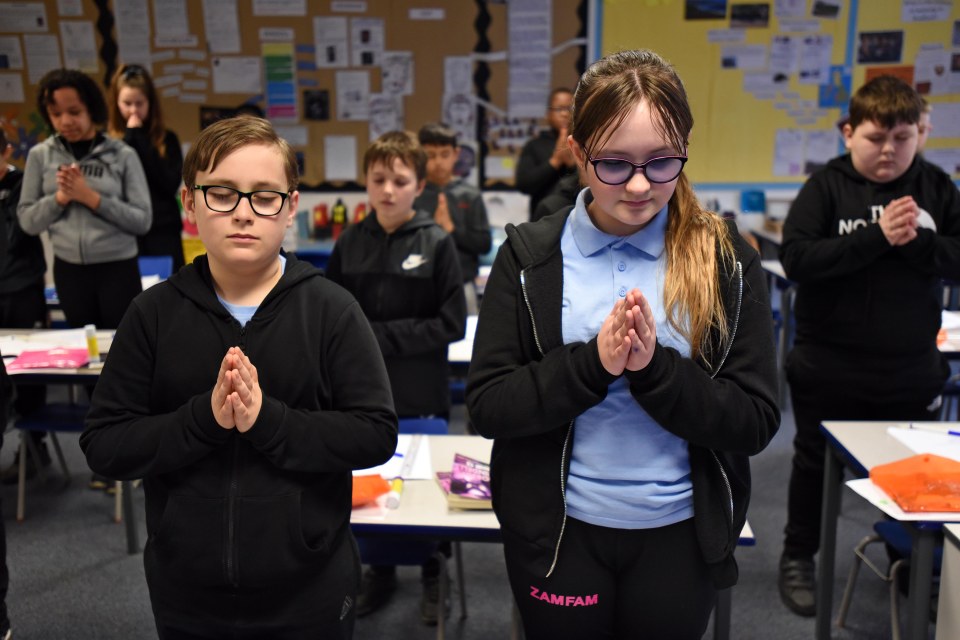 Year six pupils at the Academy at St James school, Allerton, Bradford, take part in the national minute’s silence