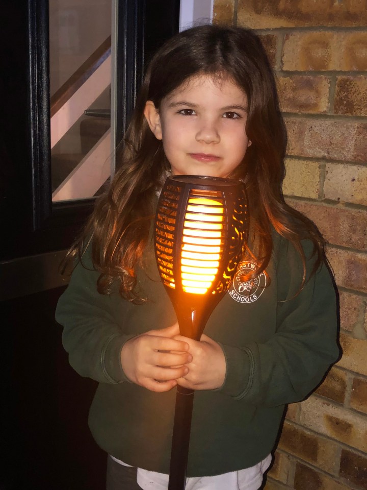 Dorrie Cunningham, 8, held a torch in Surrey to remember those who have lost their lives in the past year