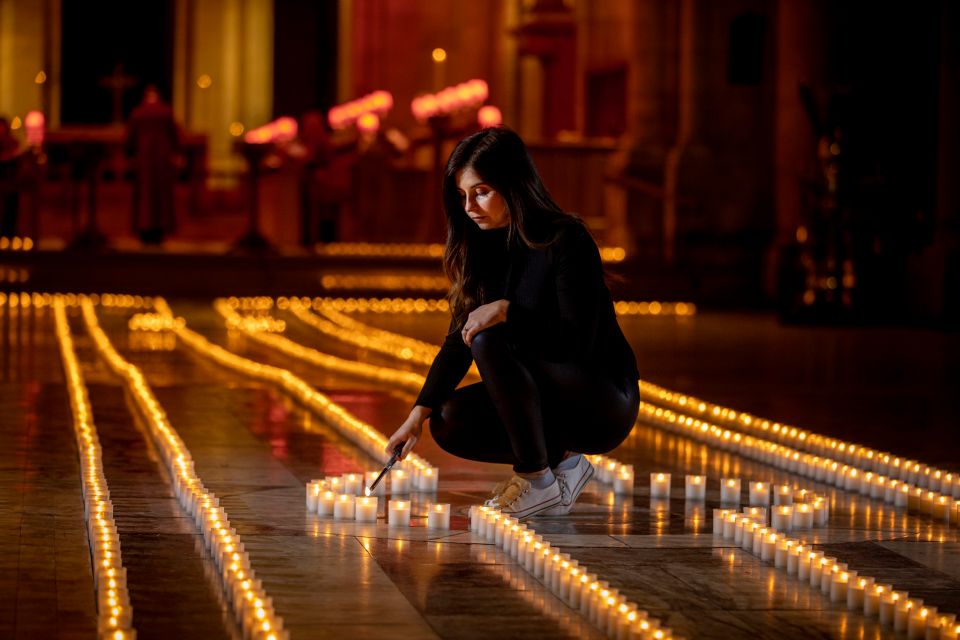 Holly Wilson, whose gran passed away during the pandemic, lights a candle in Belfast Cathedral before a remembrance service