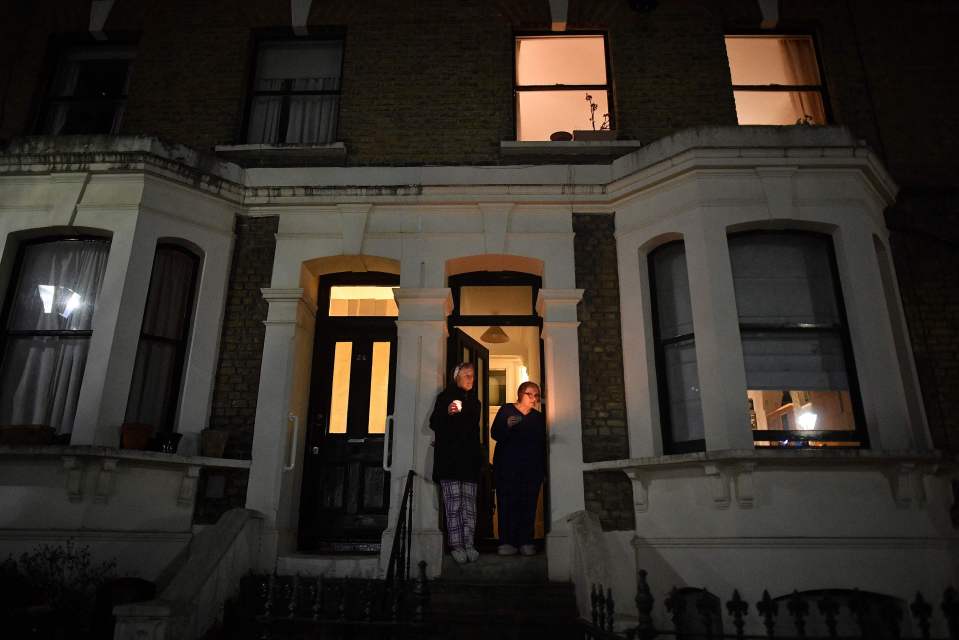 Residents in Kennington, south London, held candles on their doorstep as the nation remembered the those who died from Covid