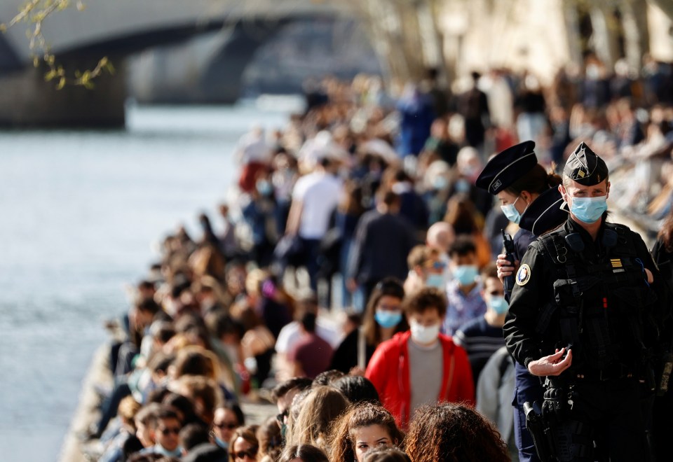 French cops kept an eye on the crowds gathered on the banks of the Seine