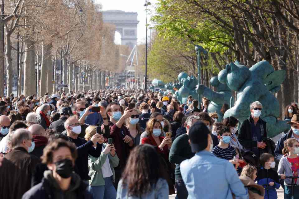 People admired an outdoors exhibition along the Champs-Elysees