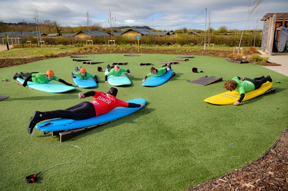 People are instructed how to surf at The Wave in Bristol as exercise classes resume