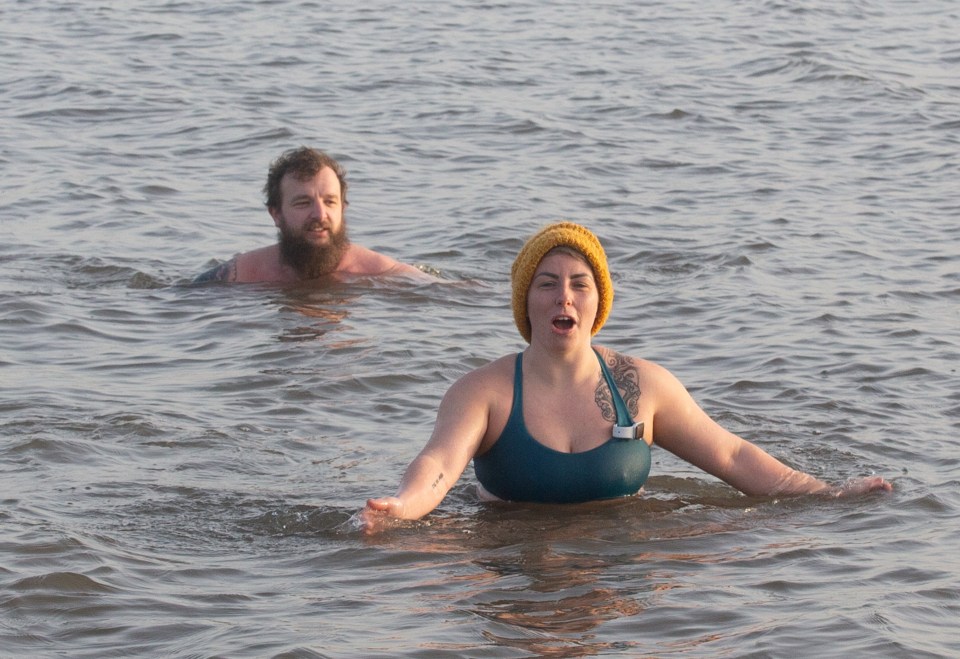 Early morning swimmers brave the cold water in the River Mersey