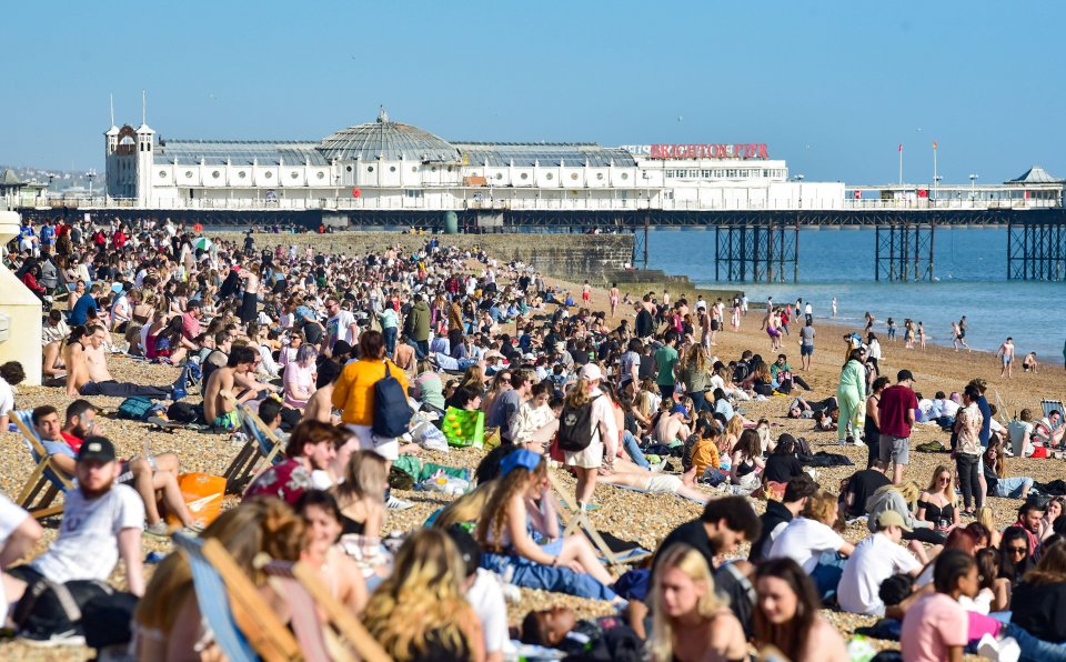 Brighton beach has been packed as visitors flock to the seaside on the hottest day of the year