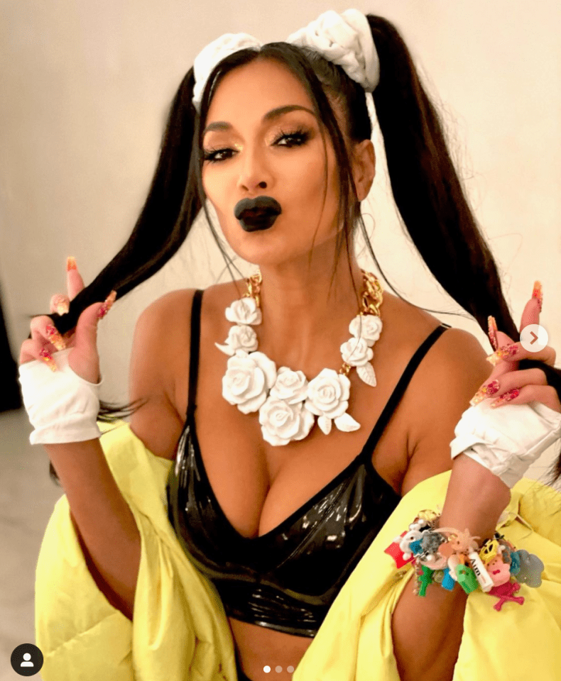 Nicole Scherzinger looked incredible in a PVC crop top and bunches in behind the scenes pics from new video