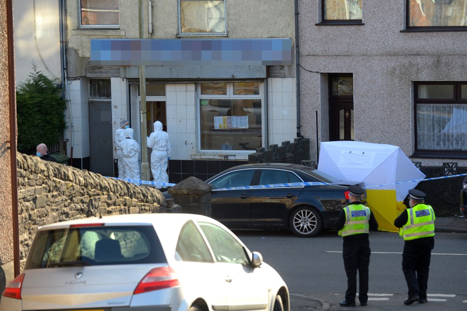 A white police forensic tent was set up outside the takeaway