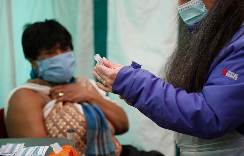 Prof Altmann said the new variant could slow down the UK's vaccine rollout. Pictured: Margaret Duncan-Williams, 63, waits to receive her first dose of  vaccine from Dr Jacqueline Marshall at a pop-up vaccination unit in Kilburn on February 28