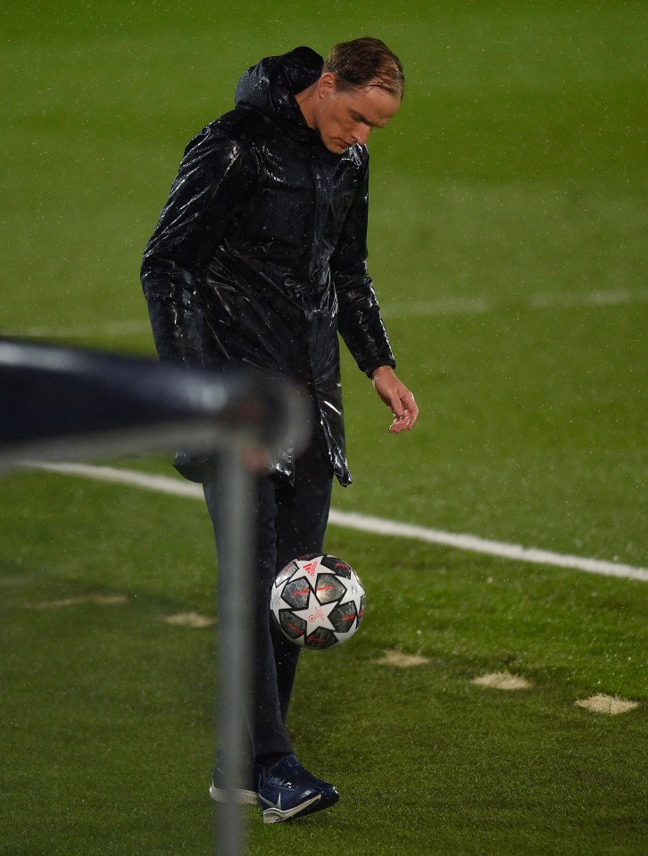 Thomas Tuchel and his rain-soaked coat have some fun with the football