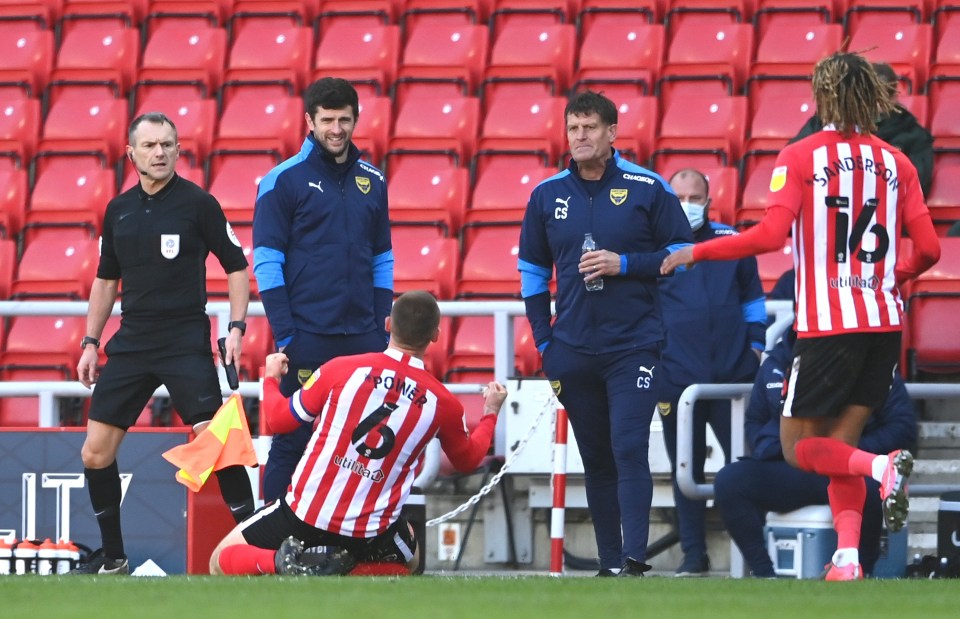 Max Power celebrates his goal by sliding in front of the visiting Oxford bench