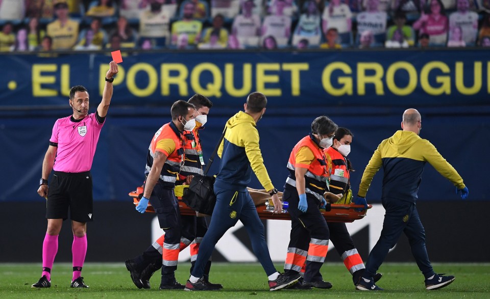 Etienne Capoue is shown the red card for Villarreal as he is carried off