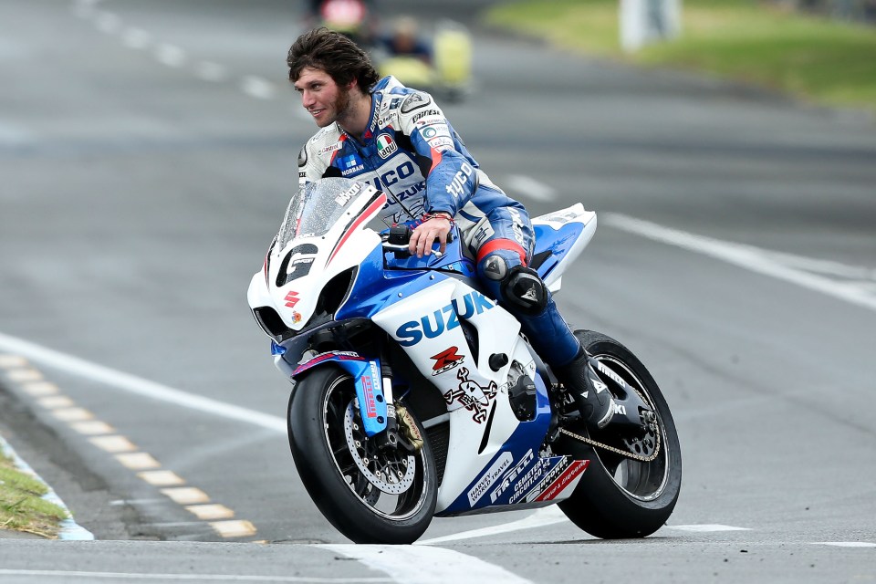 Guy Martin on a Suzuki motorcycle at a racetrack.