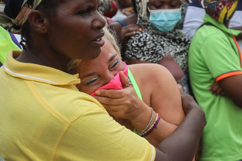 A woman cries as she waits for her son to arrive in Pemba