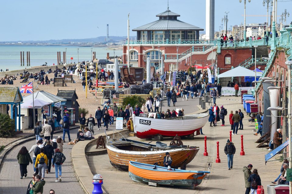 Visitors on Brighton seafront enjoy the sunny but chilly weather on the Good Friday