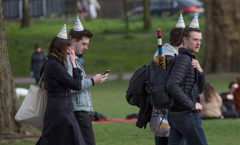 Members of the public enjoy the sun by the canal on Good Friday in Victoria Park, east London