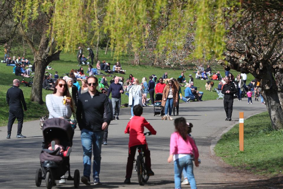 People enjoy the sunny weather in Sefton Park in Liverpool