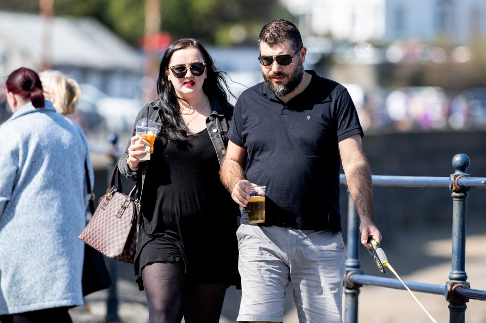 The warm weather was a chance to enjoy few drinks, like this couple at the Mumbles, near Swansea