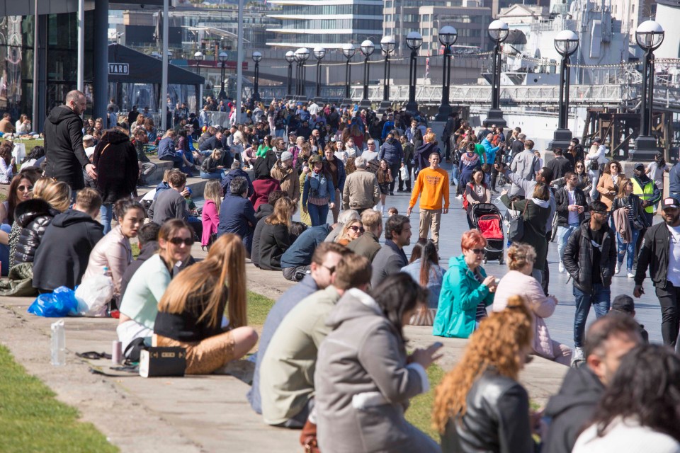 Crowds gathered by the Thames near Tower Bridge